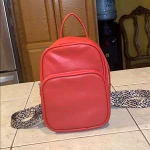 Red mini backpack with leopard print straps